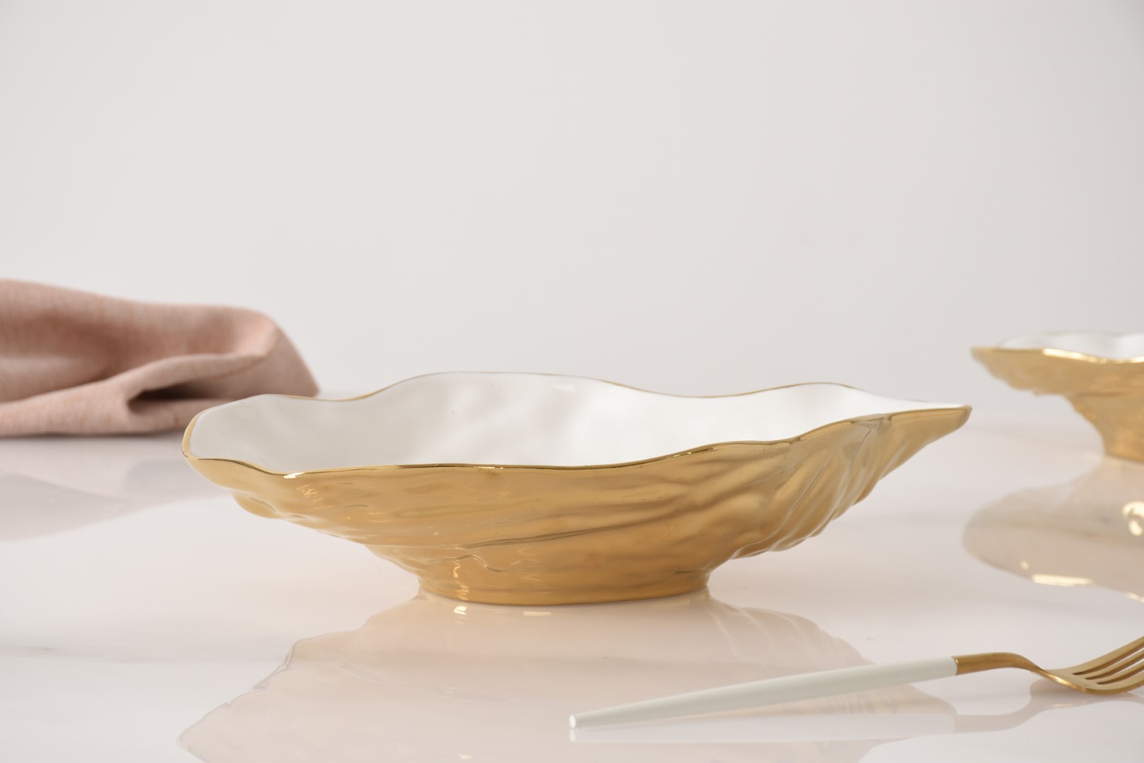CER1977WG-5 cer1977wg 5 <p data-start="282" data-end="481">Елегантна порцелянова чаша <strong>Medium Oyster Bowl</strong> у формі мушлі устриці стане вишуканою деталлю сервірування. Біла глянцева внутрішня поверхня гармонійно поєднується із золотим оздобленням зовні, а незвичайна форма ідеально підходить для подачі морепродуктів, закусок, салатів або соусів.</p>